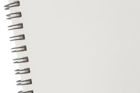 blank page of sketchbook with spiral binder against white