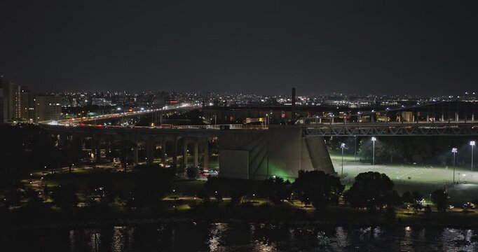 NYC New York Aerial v278 flyover East river along RFK Bridge from Randalls Island towards Queens capturing interstate freeway traffic on the crossing at night - Shot with Inspire 3 8k - September 2023