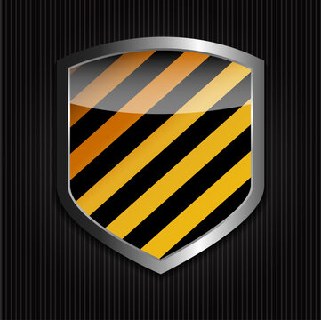 Orange and black striped shield with metallic frame on dark textured background