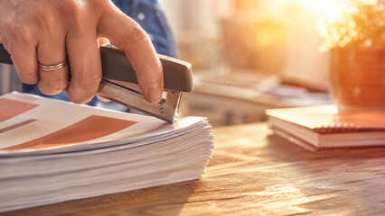 Fototapeta premium Stapler binding a stack of documents
