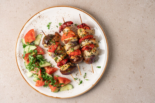 Fresh high protein chicken breast skewers served with roasted red onion and bell pepper, healthy grilled meal concept. Nutritious clean eating lifestyle food photography featuring lean protein