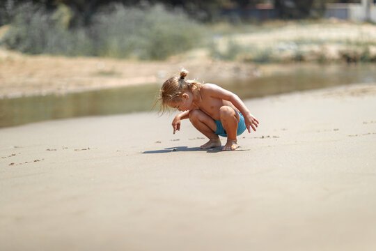 Curious Toddler Exploring Sandy Beach