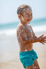 Happy Child Splashing Beach Water © Anna Om