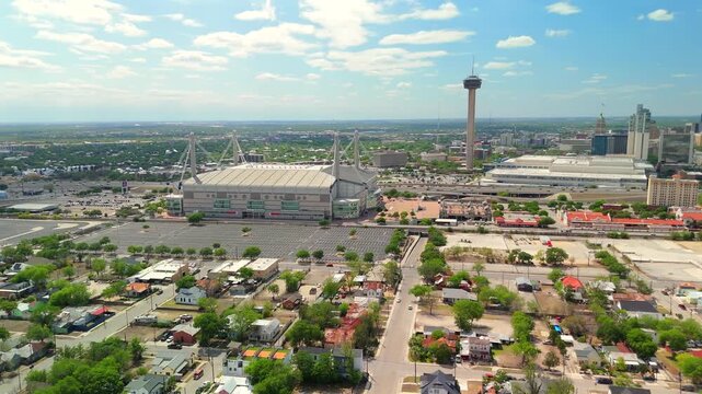 A time lapse drone orbits the iconic Tower of the Americas and Alamodome as clouds drift overhead.
