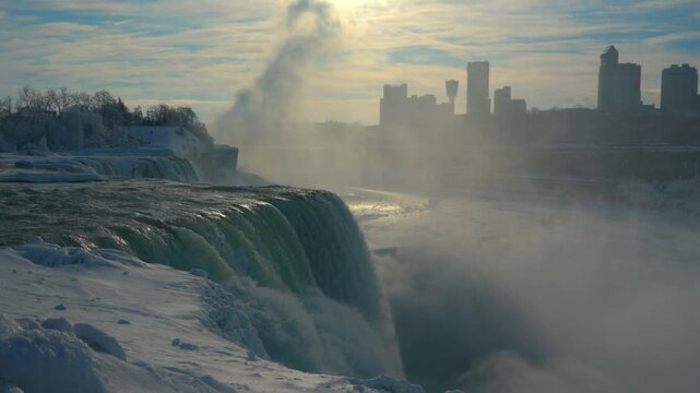 A sweeping panorama captures the entire winter gorge with powerful turquoise falls