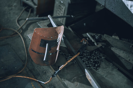 Close Up of Welding Helmet and Metalworking Tools in Small Community Machine Shop Workshop