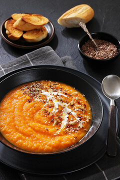 spiced sweet potato soup in a black bowl