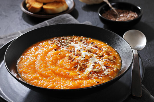 spiced sweet potato soup in a black bowl
