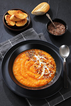 spiced sweet potato soup in a black bowl