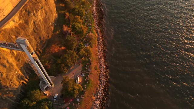 Top down aerial drone shot captures the Boca do Vento scenic elevator built into dramatic cliffs above the Tagus River.
