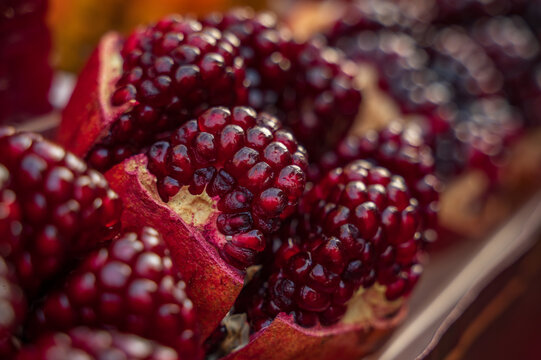 Close-up of ripe pomegranate seeds displayed for sale at a traditional local market in Thailand.