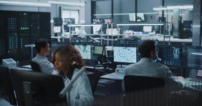 Diverse Team of Scientists work on Computers in Advanced Medical Research Laboratory, Examining Brain Scans, Molecular Structures With AI Technology to Augment Drug Development and Disease Treatment