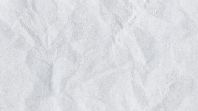 Close-up of crumpled white paper texture with subtle shadows and soft lighting