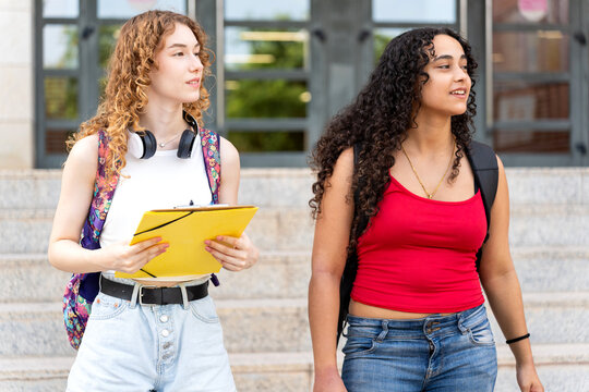 Diverse university students walking on campus, starting classes and new friendships