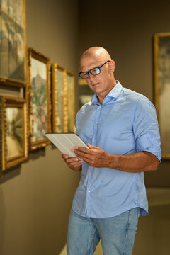 Man in the museum looks at art exhibitions gallery