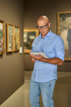 Man in the museum looks at art exhibitions gallery