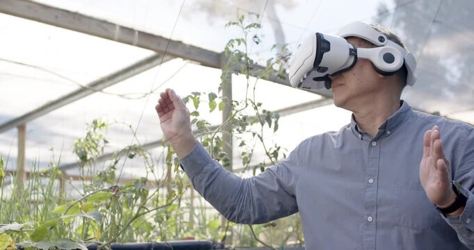 Mid Adult African woman wearing VR headset, grey shirt, activating UI, scanning plants, copy space