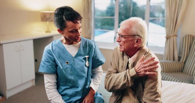 Talking, caregiver and shoulder pain of senior man in home for healthcare, elderly support or wellness. Retirement, nurse and old person with patient care, homecare and stiff joint with arthritis