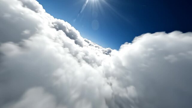 Immersive aerial flight through fluffy white clouds in a bright blue sky, cinematic drone perspective flying above the cloud layer with sunlight flares.