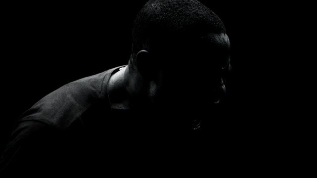 African american man screaming in agony and distress. Portrait of male experiencing mental breakdown, emotional pain, burning out and psychological struggle.