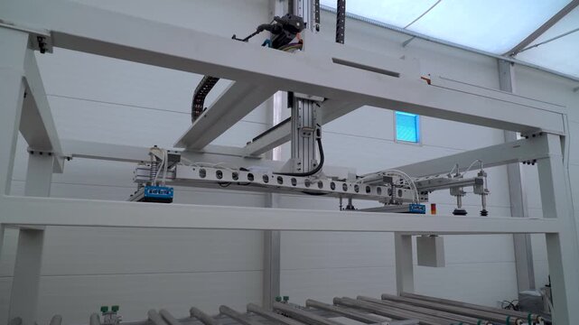 Gantry robot moving along axes in an automated manufacturing industrial production line
