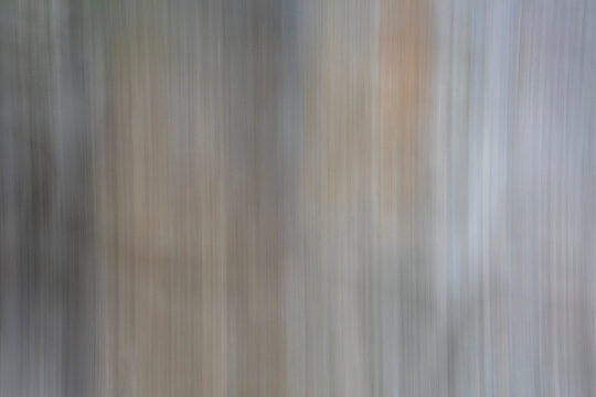 Abstract minimalist texture using Intentional Camera Movement (ICM). Vertical motion blur in slate grey and taupe tones creates a sophisticated, fluid metallic grain for creative design utility.