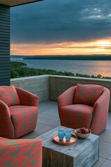 Fototapeta premium Elevated terrace with patterned armchairs and wooden coffee block overlooking a waterfront sunset for balcony background and peaceful outdoor lounging