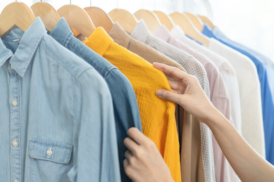 Close-up hands of person choosing clothes to wear