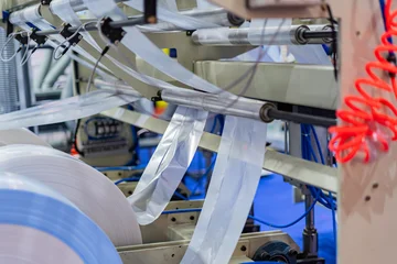 Plastic bag manufacturing machine  Automatic polyethylene plastic bag production machine roller of the plastic bag production machine  product packaging concept © Photo Gallery