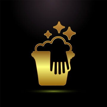 Shiny gold cleaning bucket with sparkling bubbles and hand contour on black.