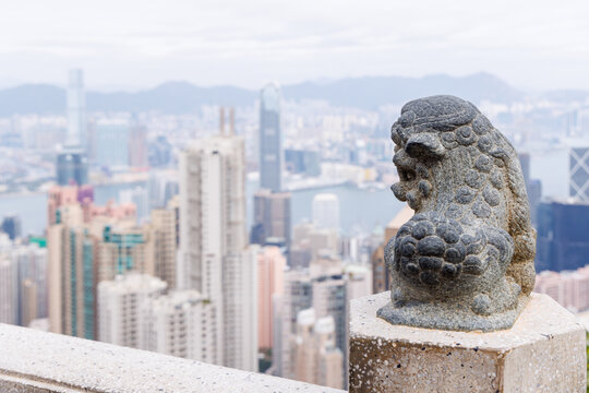 Hong Kong - Victoria Harbour skyline view of the city from hill with green plants in foreground