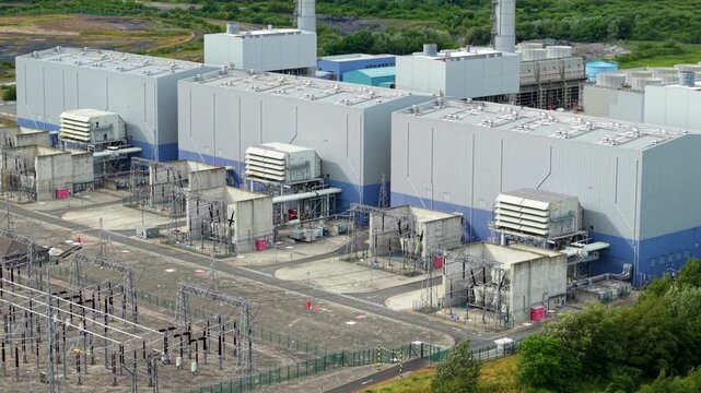 Close up aerial view of gas turbine generation houses and high voltage electrical switchgear at a power station near Gainsborough, UK.