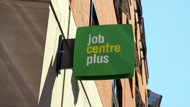 Leicester, England, UK - 6 July 2026: Jobcentre Plus green sign on brick wall facade, UK government employment agency billboard, outdoor public sector office decoration close up