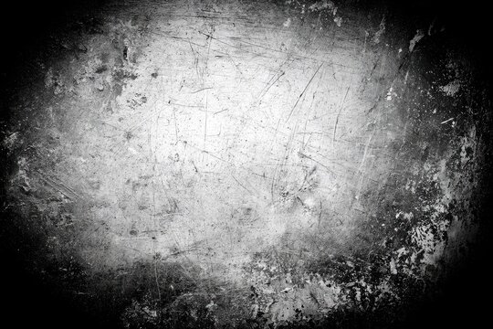 Grungy scratched metal surface with dark vignette and mottled textures