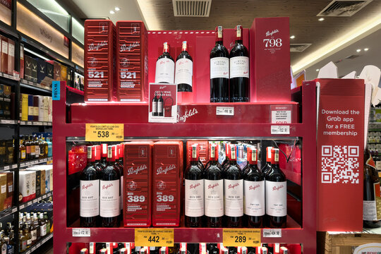 PENANG, MALAYSIA - JUL 06, 2026: Penfolds wine bottles and gift boxes displayed in supermarket liquor section.