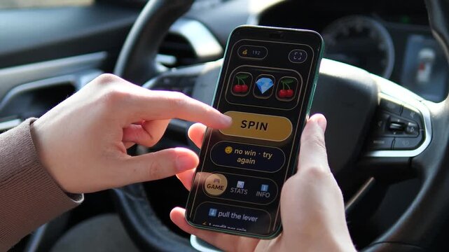 Mobile slot machine gameplay in a car. User taps SPIN, faces a loss with diamonds and cherries, and tries again. Perfect for mobile gaming ads, casino app promos, and gambling UI showcases.