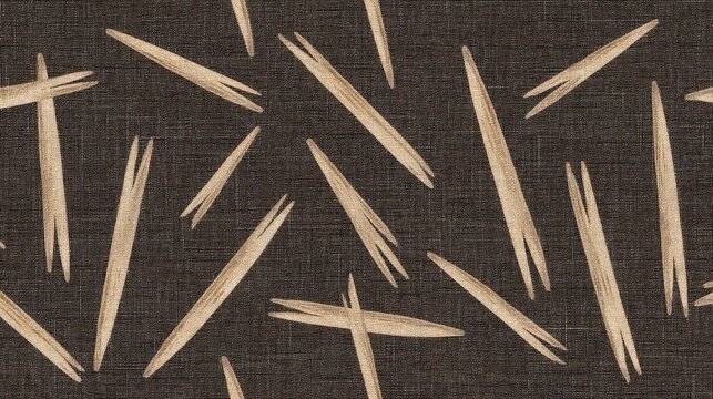 Collection of wooden toothpicks scattered on dark fabric background