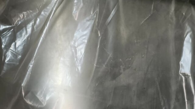 Transparent Plastic Wrap Texture with Wrinkled and Creased Cellophane Surface Background