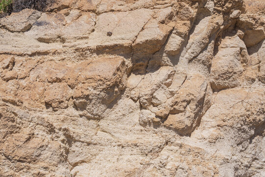 Ancient lava rock formations with distinctive geological layers in Tenerife's volcanic landscape.