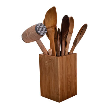 Rustic wooden meat tenderizer mallet and cooking utensils in a square bamboo block isolated