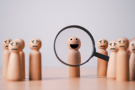 Magnifying glass highlighting a happy person among worried individuals, symbolizing positive mindset, emotional resilience, mental wellness, optimism, confidence and personal growth.