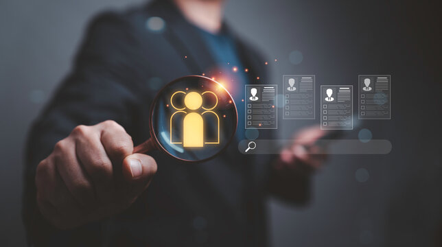 Business professional using a magnifying glass to search candidate profiles, symbolizing talent acquisition, recruitment, employee screening, HR analytics, hiring process and workforce management.