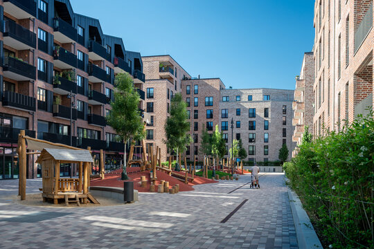 Modern apartment buildings surrounding a public playground
