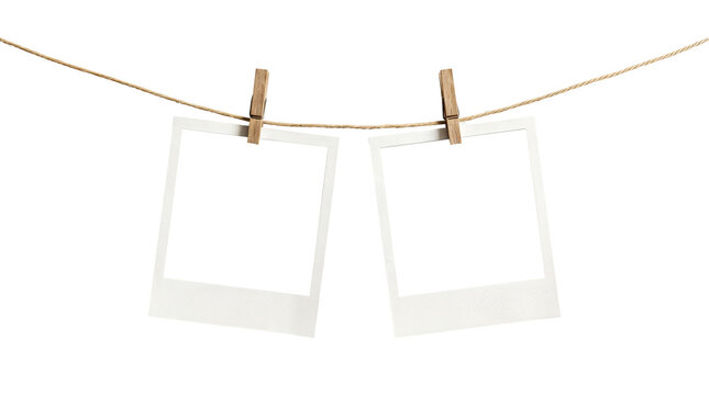 Blank Polaroid photos on a clothesline, hanging Polaroid pictures, white instant photos, clip on string
