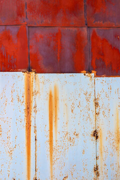 painted white and red rusty steel sheets on wall