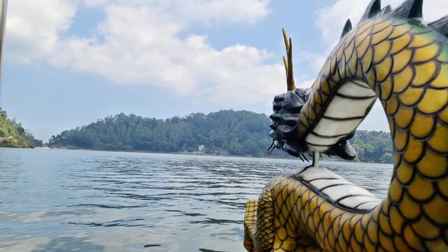 Ponorogo, Indonesia - 8 July, 2026: Editorial scenic shot of colorful recreational speedboats with racing decals moored at a mountain lake during a sunny weekend.