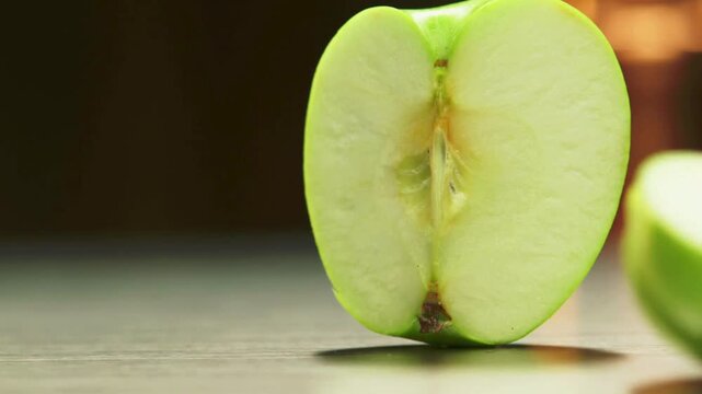 Fresh green apple cut in half, healthy snack, fruit slice, close-up