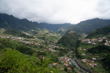 Fototapeta premium Santana, Madeira, Portugal. Charming rural village known for its traditional triangular thatched houses, lush green landscapes, scenic mountain views, and rich cultural heritage. A picturesque destina