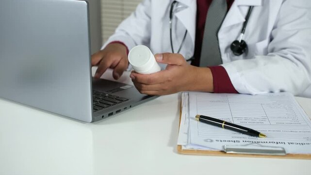 A doctor writes a prescription for a patient. A doctor writes a health note and a patient's medical record on his laptop. A close-up of a medicine bottle with a doctor typing on his laptop in the back