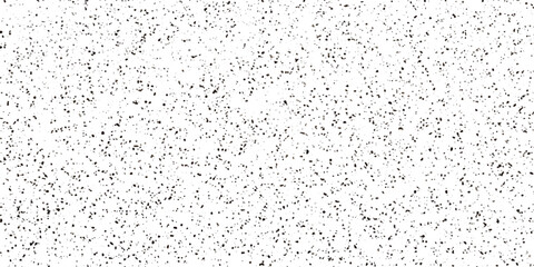 A high-angle shot of scattered black dots on a white background, creating a textured, abstract pattern. © MdKefaitUllah